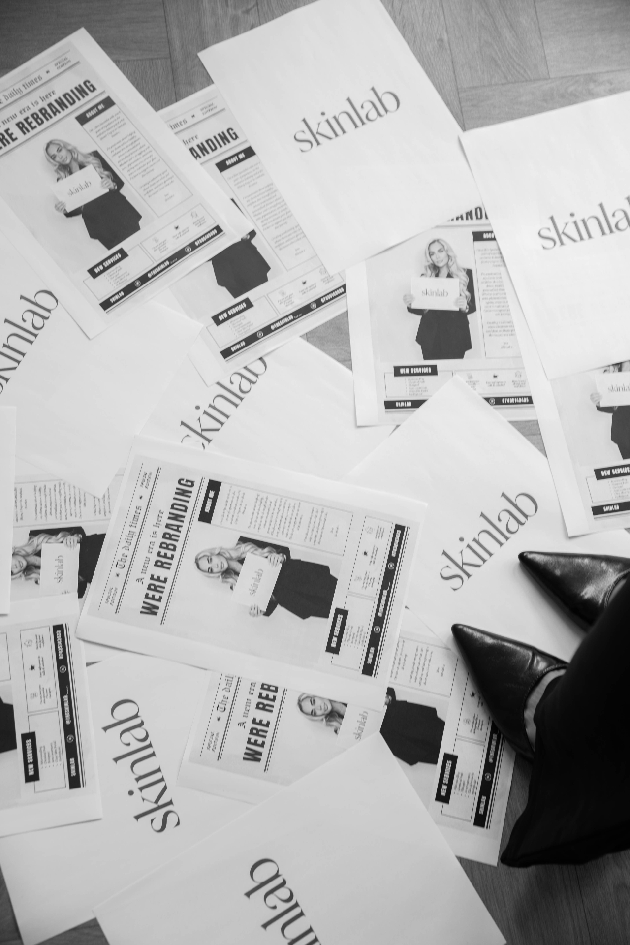 Flatlay of printed rebrand newspapers for a beauty studio