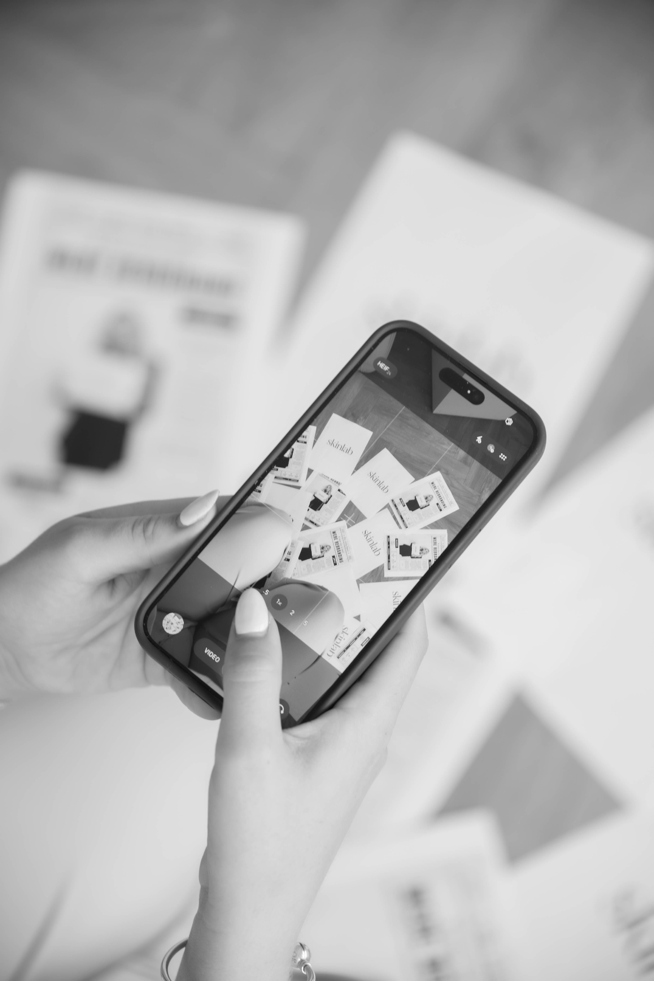 Behind the scenes phone shot of a branded print flatlay