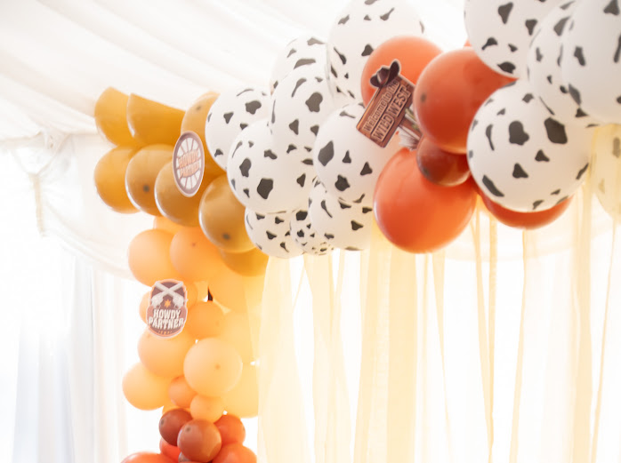 Western themed balloon arch at a charity rodeo evening