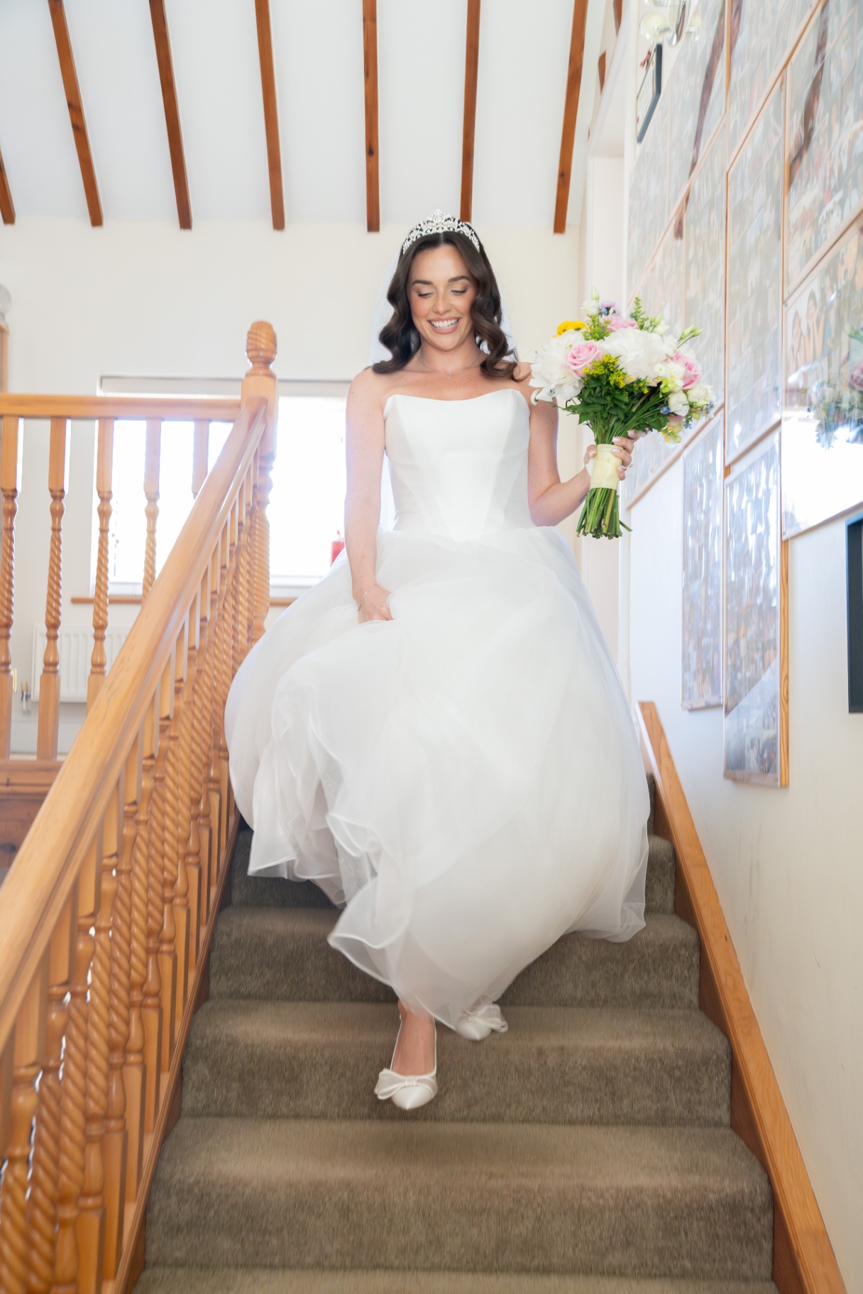 Bride walking down the stairs on the morning of the wedding